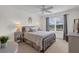 Inviting bedroom with neutral decor, plush bedding, and ample natural light from the window at 1755 Lakewood Dr, The Villages, FL 32162