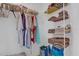 Walk-in closet with wire shelving and a variety of clothing items and folded towels at 1755 Lakewood Dr, The Villages, FL 32162