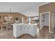 Open floor plan kitchen features white cabinets, a center island, and views into the living and dining areas at 1755 Lakewood Dr, The Villages, FL 32162