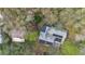 Aerial view of a home with solar panels and lush landscaping near the lake at 17561 Seidner Rd, Winter Garden, FL 34787