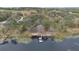 Aerial view of the lakefront property, including the dock and the lily pads at 17561 Seidner Rd, Winter Garden, FL 34787