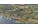 Aerial view of the lakefront property, including the dock and the lush surrounding acreage at 17561 Seidner Rd, Winter Garden, FL 34787