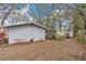 View of backyard showing greenhouse and property line with trees and garden space at 17561 Seidner Rd, Winter Garden, FL 34787