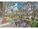 Balcony seating area with view of the yard and lake beyond at 17561 Seidner Rd, Winter Garden, FL 34787