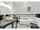 Elegant bathroom featuring a clawfoot tub, marble countertops, and stylish fixtures, creating a luxurious spa-like experience at 17561 Seidner Rd, Winter Garden, FL 34787