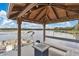 Covered dock with seating area, fire table, and boat parking on the lake at 17561 Seidner Rd, Winter Garden, FL 34787