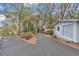 Long paved driveway with blooming azaleas leading to the house and detached garage at 17561 Seidner Rd, Winter Garden, FL 34787