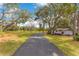 Scenic driveway leading to the home, surrounded by mature trees and landscaping on a sunny day at 17561 Seidner Rd, Winter Garden, FL 34787