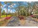 Dual driveway entry bordered by bright pink azaleas and mature trees, leading to the main house at 17561 Seidner Rd, Winter Garden, FL 34787