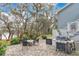 Covered patio features a dining table and barbecue and overlooks the lake at 17561 Seidner Rd, Winter Garden, FL 34787