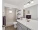 Bright bathroom with a tub and shower combo, gray vanity, and stylish mirror at 17834 Se 105Th Ave, Summerfield, FL 34491