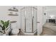 Clean bathroom featuring a modern shower and toilet, accented by decorative shelves and plants at 17834 Se 105Th Ave, Summerfield, FL 34491