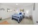 Comfortable bedroom with matching nightstands, light carpet, and bright windows at 17834 Se 105Th Ave, Summerfield, FL 34491