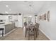 Open-concept dining area with wood-look floors, seamlessly connecting to the kitchen at 17834 Se 105Th Ave, Summerfield, FL 34491