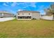 View of large backyard featuring a well-maintained lawn and white fencing at 1787 Sunset Ridge Dr, Mascotte, FL 34753