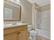 This is a standard bathroom with a shower/tub, a toilet, and a single sink vanity with a matching framed mirror at 1787 Sunset Ridge Dr, Mascotte, FL 34753