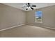 Cozy bedroom with neutral walls, carpeted floors, a ceiling fan and a window that provides natural light at 1787 Sunset Ridge Dr, Mascotte, FL 34753