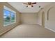 Bedroom featuring neutral carpet, a ceiling fan, and a bright window at 1787 Sunset Ridge Dr, Mascotte, FL 34753