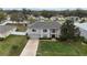 Aerial view of an attractive home boasting mature landscaping and a large driveway at 1787 Sunset Ridge Dr, Mascotte, FL 34753