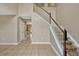 Bright foyer with tile flooring and staircase with carpeted steps at 1787 Sunset Ridge Dr, Mascotte, FL 34753