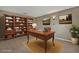 Home office featuring built-in bookshelves and a classic wooden desk at 1787 Sunset Ridge Dr, Mascotte, FL 34753