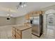 This kitchen area features stainless appliances and center island flowing into the large living room area at 1787 Sunset Ridge Dr, Mascotte, FL 34753