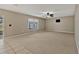 Spacious living room features neutral walls, a ceiling fan, and abundant natural light from a window at 1787 Sunset Ridge Dr, Mascotte, FL 34753