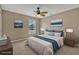 Stylishly staged main bedroom with an upholstered bed, matching nightstands and lamps, and tasteful decor at 1787 Sunset Ridge Dr, Mascotte, FL 34753