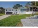 View of the backyard showing garage, play area, and screened-in porch at 1930 Hilltop Dr, Mount Dora, FL 32757