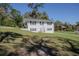 Charming two-story white home with black shutters and a spacious front yard at 1930 Hilltop Dr, Mount Dora, FL 32757