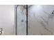 Modern shower with a glass door and marble-tiled walls at 1930 Hilltop Dr, Mount Dora, FL 32757