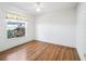 Cozy bedroom with wood floors and a window view of lush greenery at 203 Del Rio Drive, Lady Lake, FL 32159