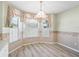 Cozy breakfast nook bathed in natural light from large windows, creating a perfect spot for morning coffee at 203 Del Rio Drive, Lady Lake, FL 32159