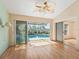 Bright living room with wood floors, ceiling fan, and sliding doors leading to the pool area at 203 Del Rio Drive, Lady Lake, FL 32159