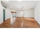 Expansive living room showcasing hardwood floors, fan, recessed lights, and sliding door to a backyard oasis at 203 Del Rio Drive, Lady Lake, FL 32159