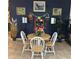 Stylish dining area with dark blue walls, elegant decor, and a well-lit round table with four chairs at 2082 Vision Ct, The Villages, FL 32163