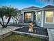 Well-manicured front yard featuring tropical landscaping, a garden statue, and an inviting entrance at 2082 Vision Ct, The Villages, FL 32163