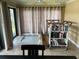 Cozy reading nook featuring a rolling bookcase, a neutral rug, and natural light from large sliding glass doors at 2082 Vision Ct, The Villages, FL 32163