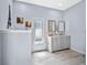 Well-lit bathroom with double vanity, modern fixtures, and tiled floors at 21849 Tartan St, Leesburg, FL 34748