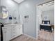 Light and airy bathroom with a double vanity and neutral toned flooring at 21849 Tartan St, Leesburg, FL 34748