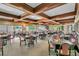 Bright dining area featuring wood-beamed ceilings, neutral carpet, and expansive windows for ample natural light at 21849 Tartan St, Leesburg, FL 34748