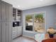 Cozy kitchen area features gray cabinets, a window view, and breakfast nook seating at 21849 Tartan St, Leesburg, FL 34748