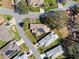 Community aerial view of homes with solar panels, manicured lawns, and mature trees in a well-maintained neighborhood at 21850 Tartan St, Leesburg, FL 34748