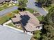 Aerial view of home showcasing solar panels, well-maintained landscaping, and a desirable neighborhood setting at 21850 Tartan St, Leesburg, FL 34748