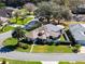 Aerial shot of house with gorgeous greenery, a well-manicured lawn, and solar panels on the roof at 21850 Tartan St, Leesburg, FL 34748