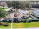 Wide-angle aerial view of a home with solar panels and beautiful landscaping in a peaceful neighborhood at 21850 Tartan St, Leesburg, FL 34748