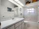 Bathroom featuring a decorative glass shower and a white vanity with ample storage at 21850 Tartan St, Leesburg, FL 34748