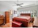 Bright bedroom with wood furniture and a decorative quilt on the bed at 21850 Tartan St, Leesburg, FL 34748