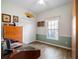 Office area of a bedroom with natural light, light walls, a closet, and built-in storage at 21850 Tartan St, Leesburg, FL 34748