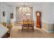 Traditional dining room featuring a quilt wall hanging and wooden grandfather clock at 21850 Tartan St, Leesburg, FL 34748